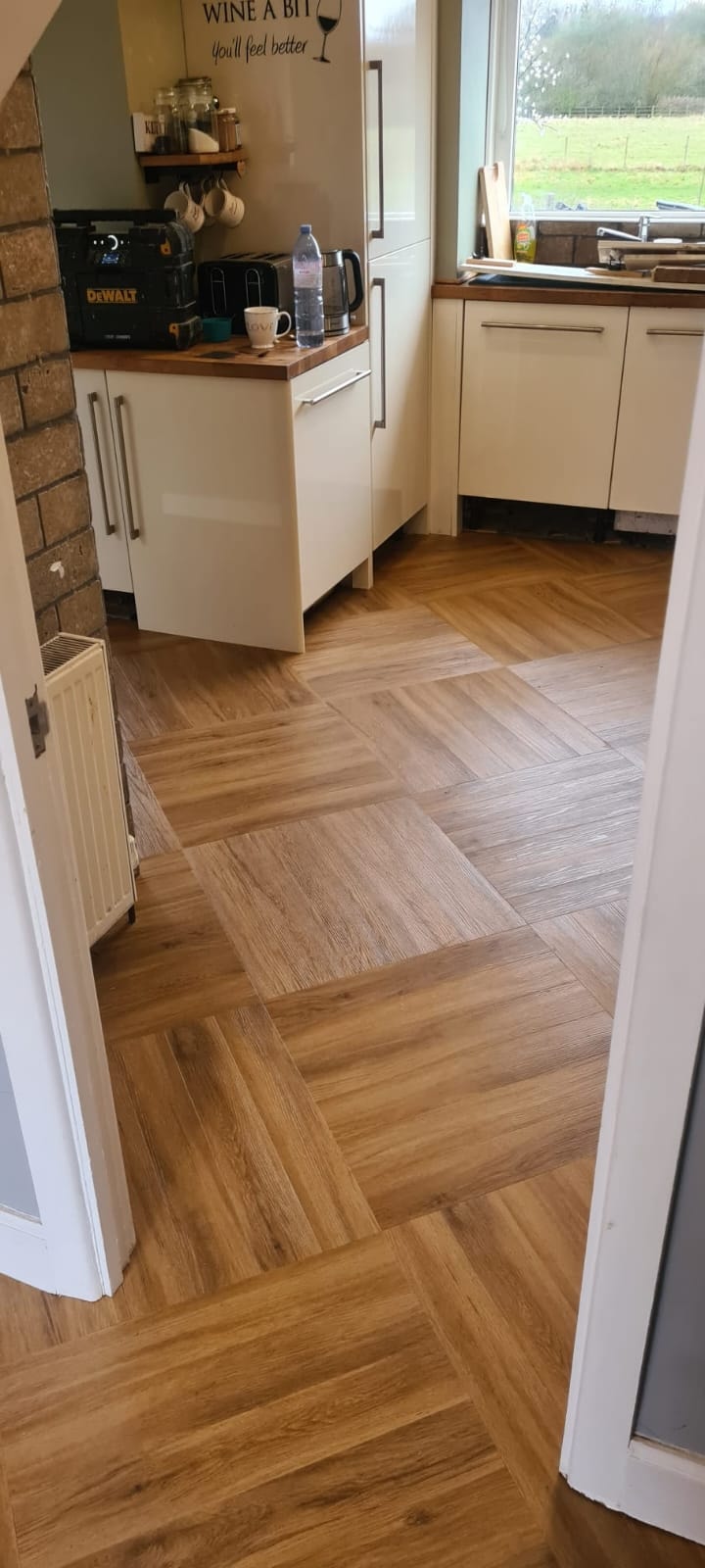 Modern kitchen with cork flooring and white cabinets