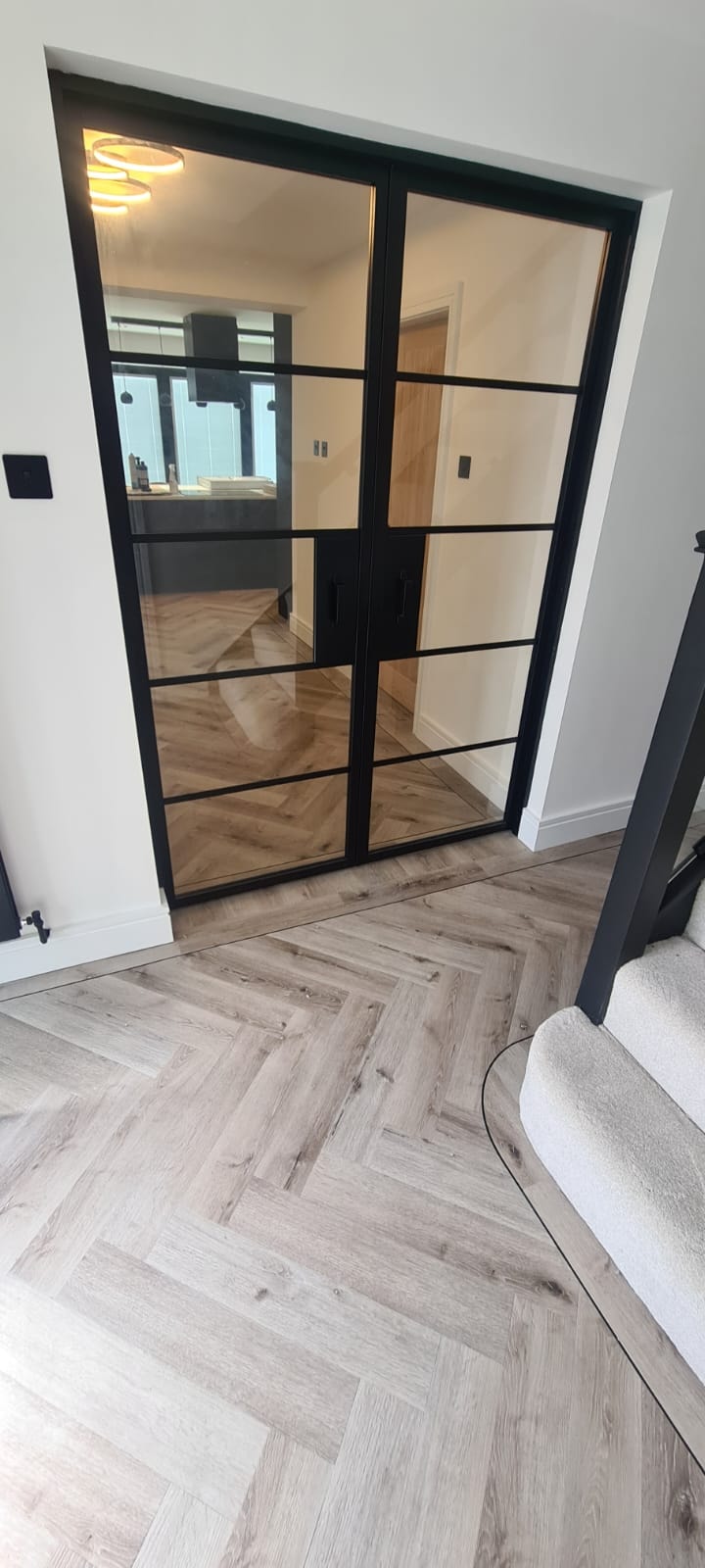 Empty apartment with herringbone wood flooring